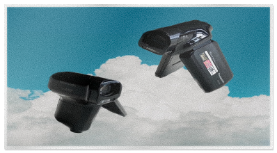strange image of two panasonic camcorders floating over a bright cloudy sky